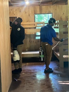 Licensed technicians applying targeted EPA-approved bed bug spray in a residential room
